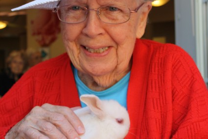 senior holding rabbit
