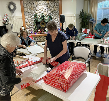 Seniors Wrapping Gifts Together