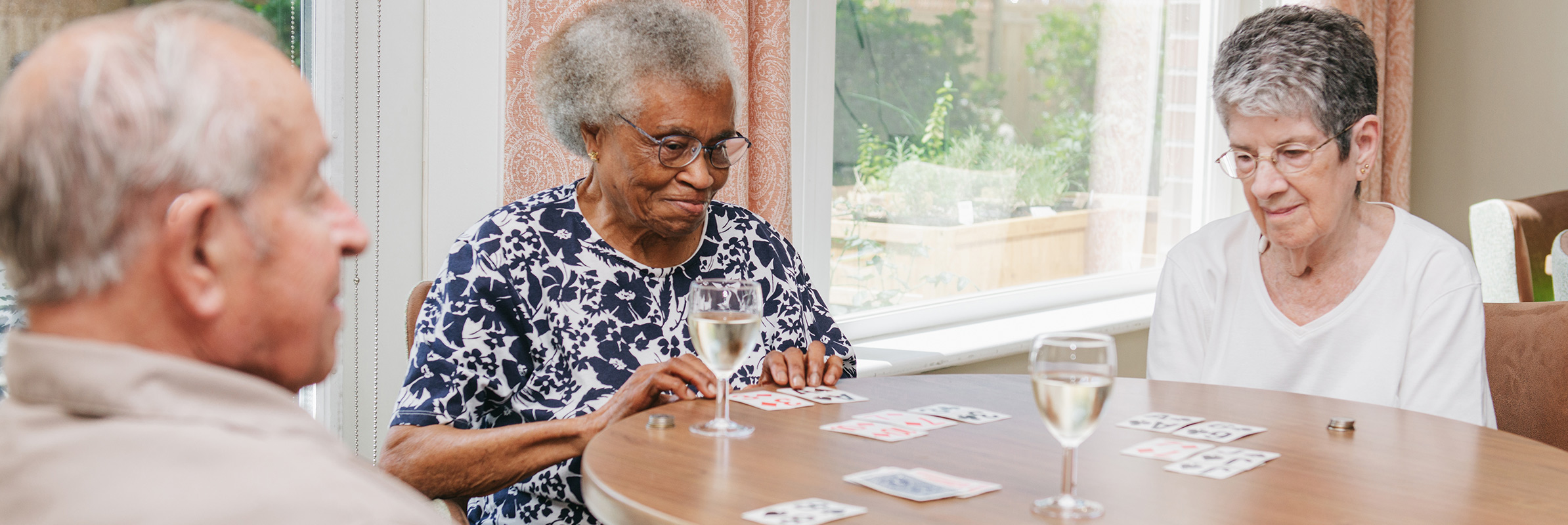 Seniors Playing Cards with Wine