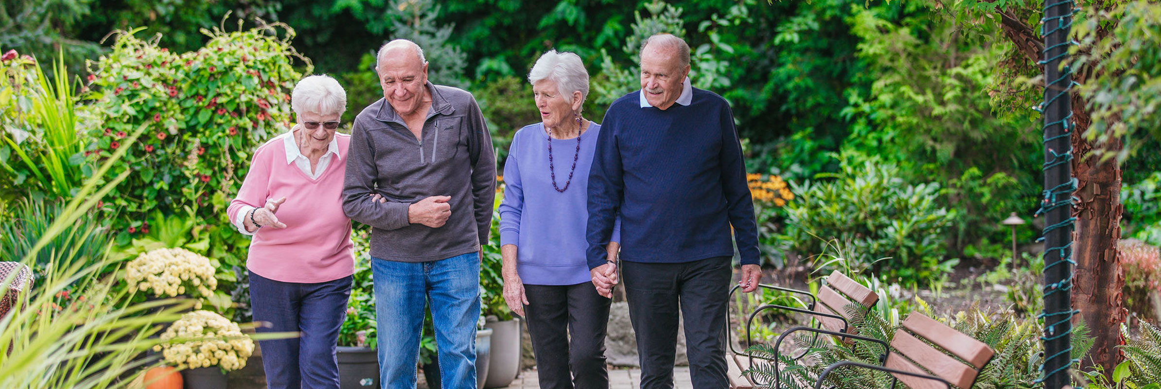 Senior Couples Walking in Garden