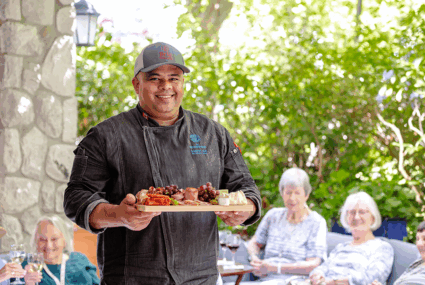 Chef serving charcuterie to seniors at The Waterford