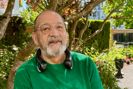 Senior man wearing neck fan