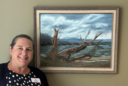 Jane Bryce General Manager of Magnolia Gardens Seniors Community in Langley with the painting